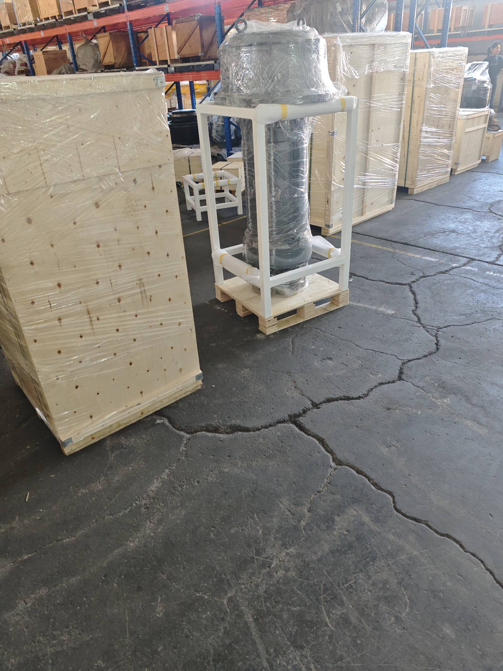 Finished export crates and a packed assembly in its shipping frame, staged for the next container